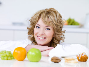 Woman with fruits and cakes Woman with fruits and cakes
